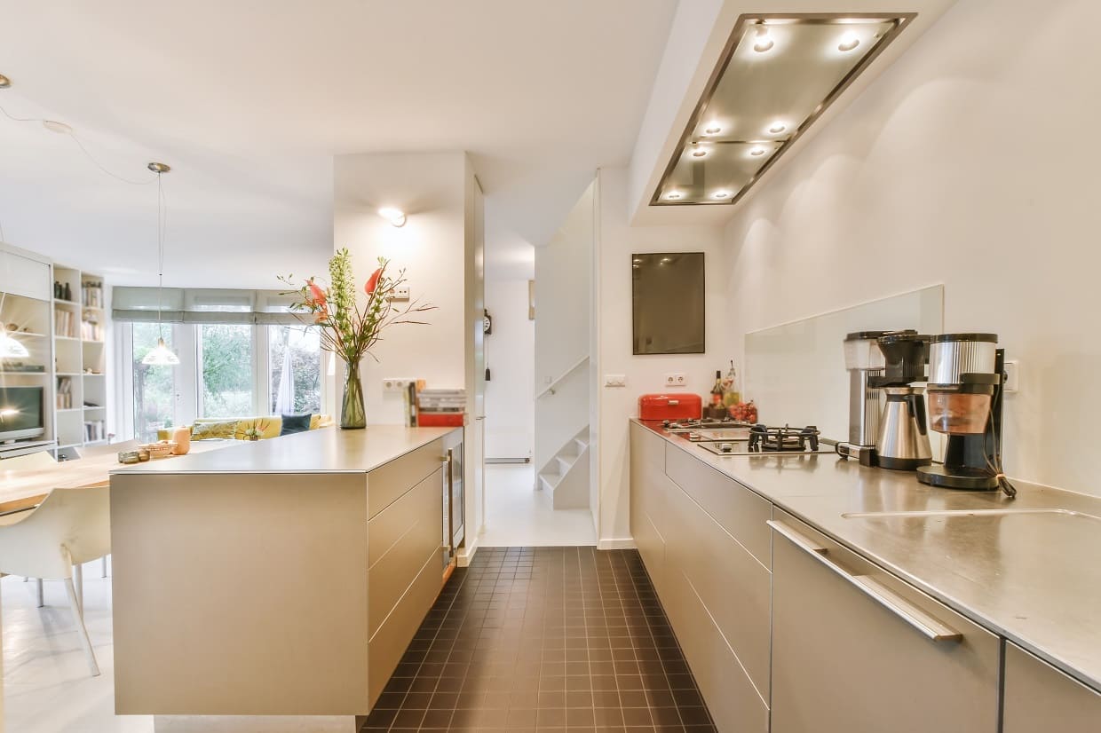 Modern kitchen with sleek countertops, stainless steel appliances, and a large island.