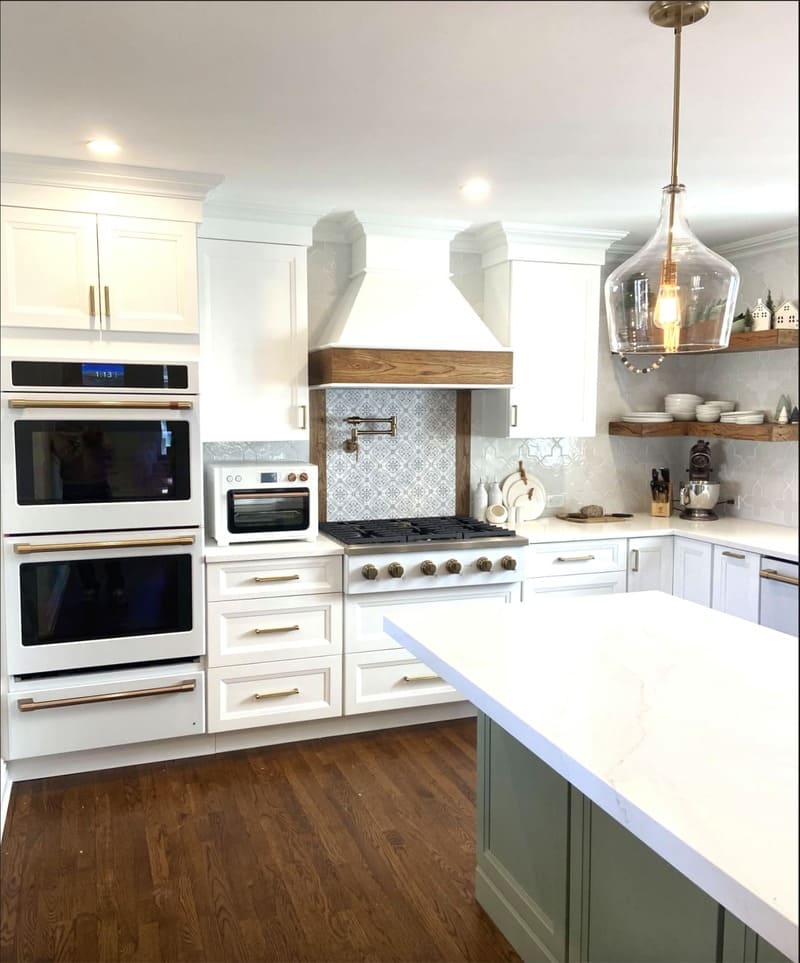 Custom Bright, modern kitchen with white cabinets, double oven, and island.
