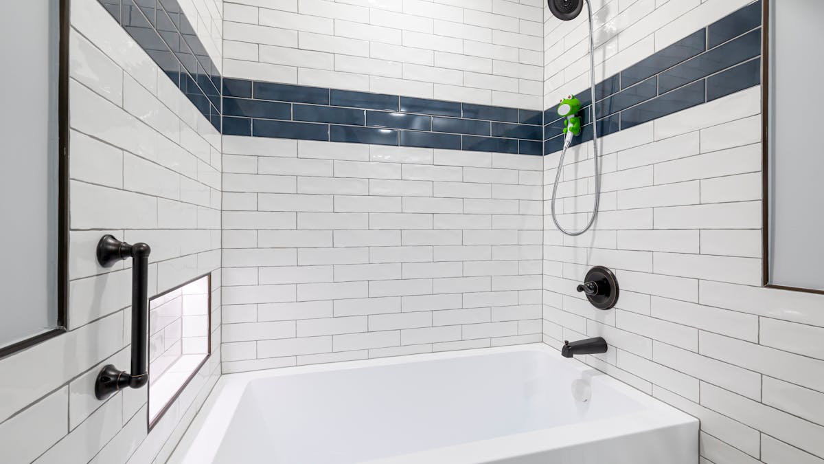 bathroom with shower and bathtub