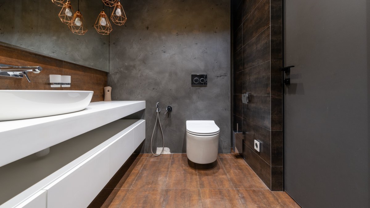 Sleek modern master bathroom featuring minimalist sink and elegant hanging lights.