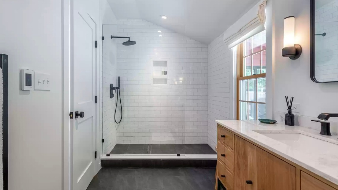 A modern bathroom with a glass-enclosed walk-in shower