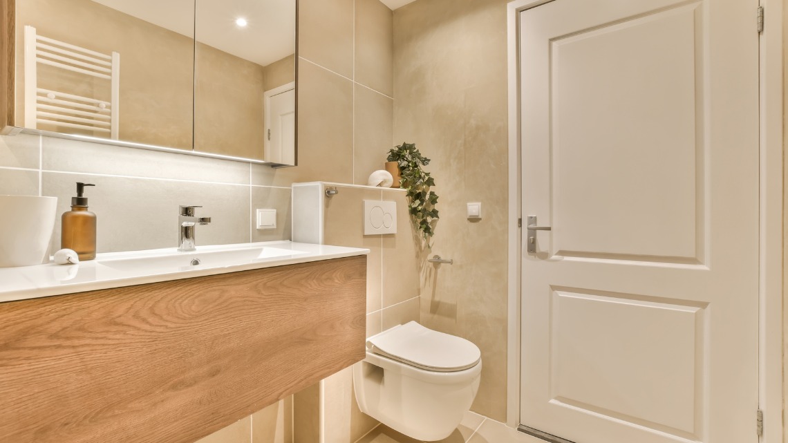 modern beige bathroom features a floating wooden vanity