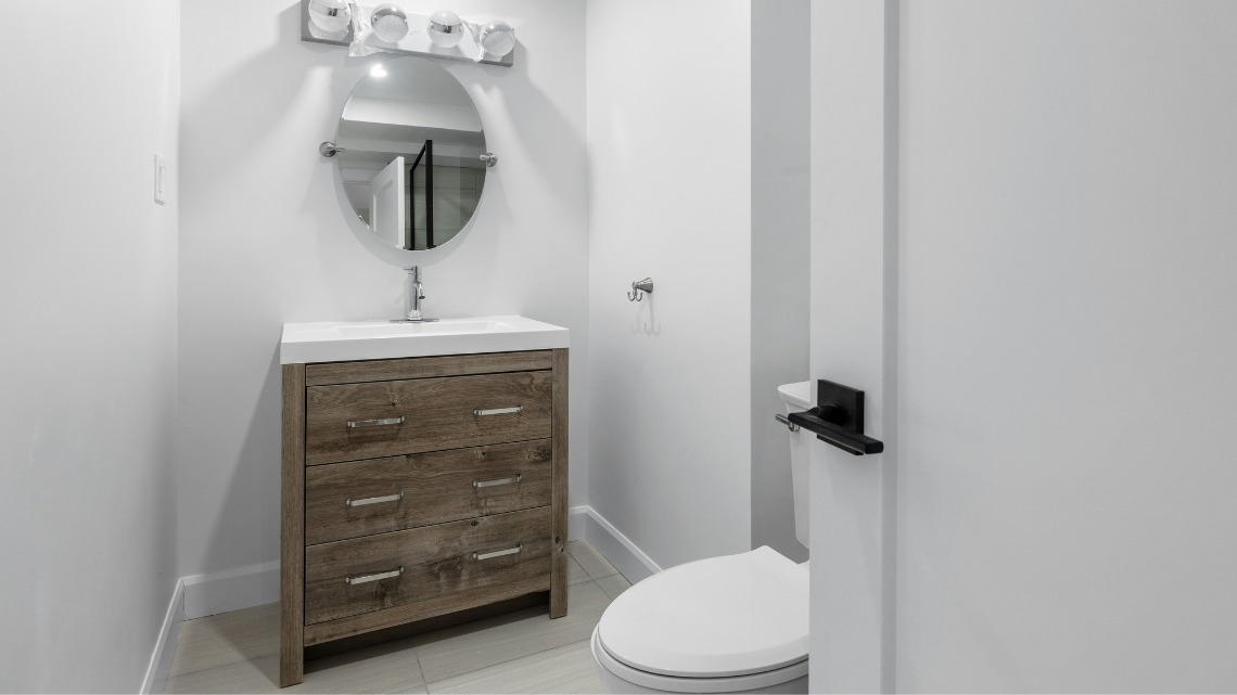 neutral bathroom features a rustic wood vanity
