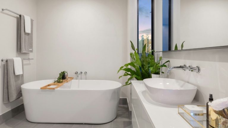 A modern bathroom with a freestanding white tub