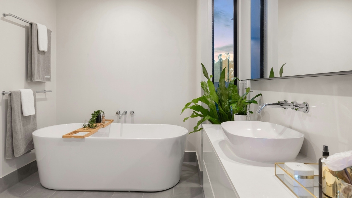 A modern bathroom with a freestanding white tub