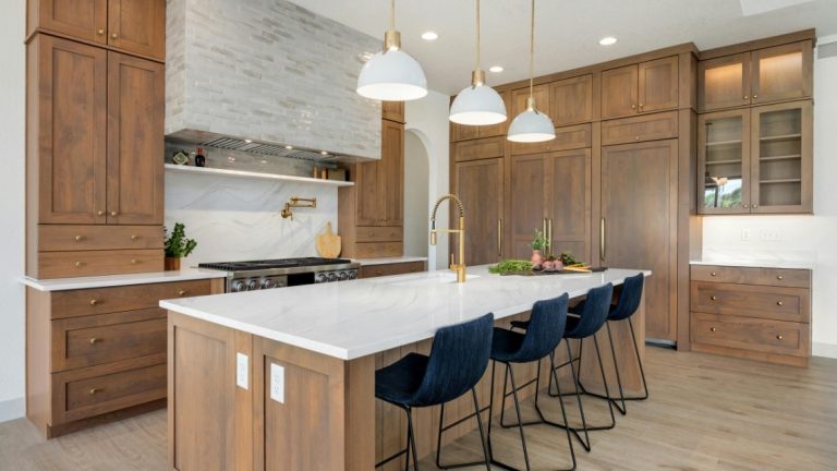 kitchen island features a sleek white waterfall quartz countertop