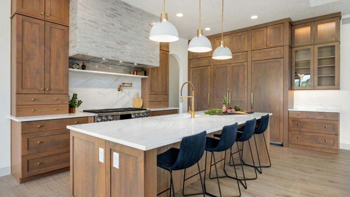 kitchen island features a sleek white waterfall quartz countertop